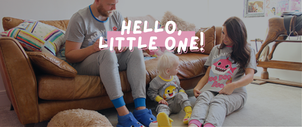 Hello, Little one. Family sat around in matching pyjs