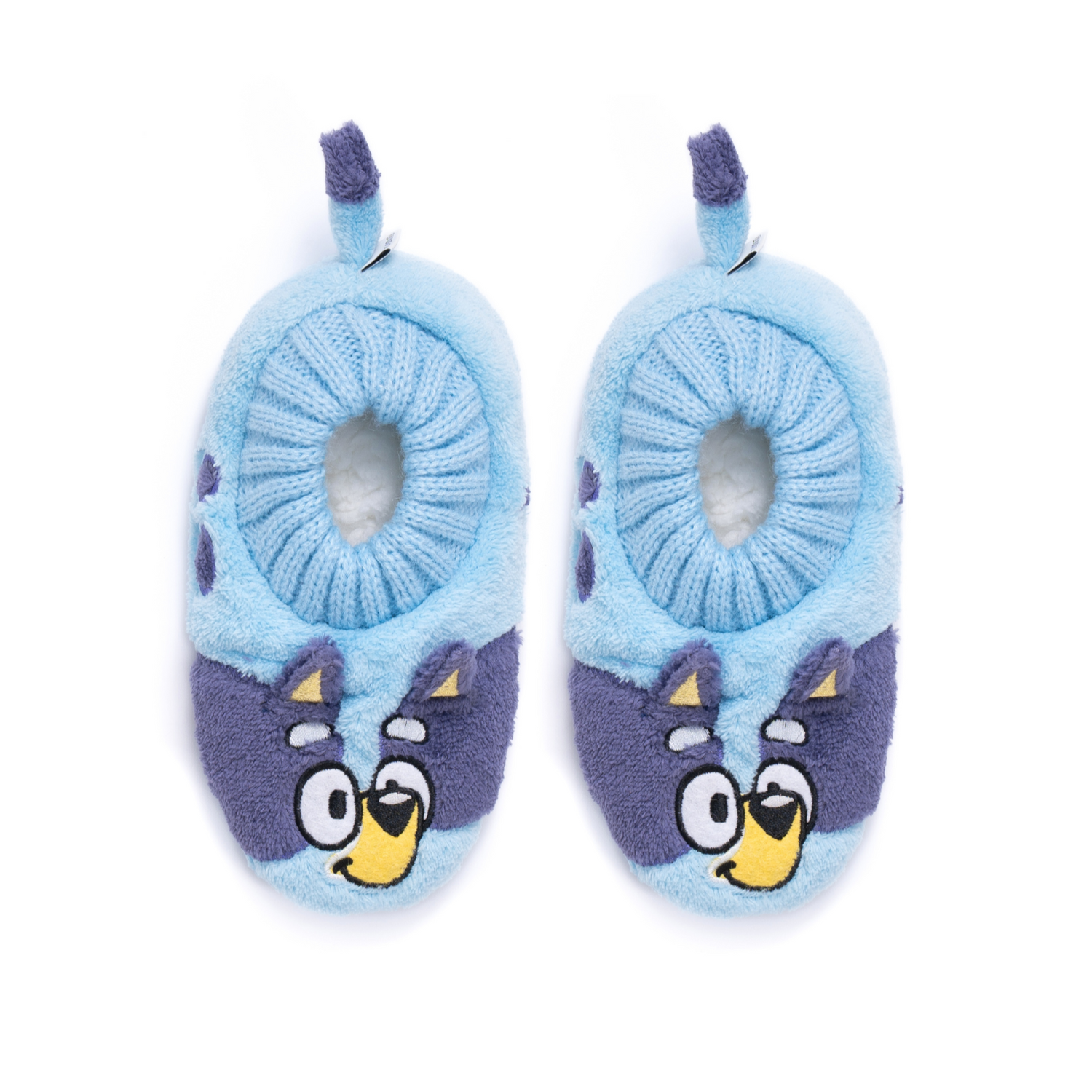 A pair of plush baby slippers in light blue and purple, featuring cartoon bluey faces on the toe area and small hanging purple loops at the top, shown on a plain white background.