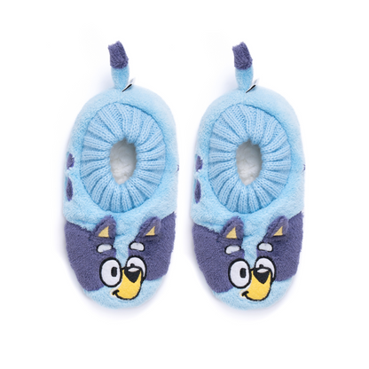 A pair of plush baby slippers in light blue and purple, featuring cartoon bluey faces on the toe area and small hanging purple loops at the top, shown on a plain white background.