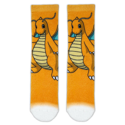 A pair of crew socks featuring a repeating graphic of Dragonite on a bright orange background, with a white gradient at the toe and heel.