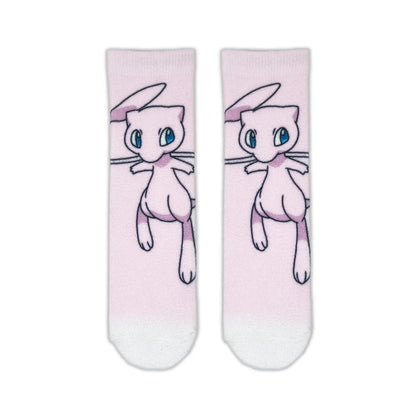 A pair of light pink crew socks featuring a printed illustration of Mew, a pink cat-like Pokémon, with blue eyes. The socks have a white toe and heel section.