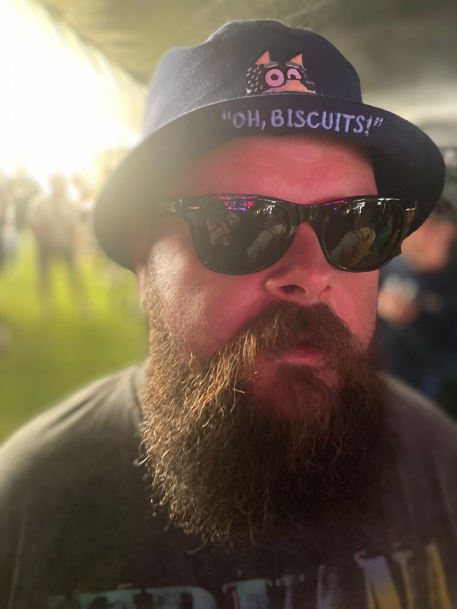 Bandit bucket hat being worn, featuring "Oh Biscuits" slogan under the rim of the bucket hat