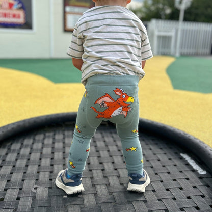 A child wearing Zog knitted leggings on a playground.