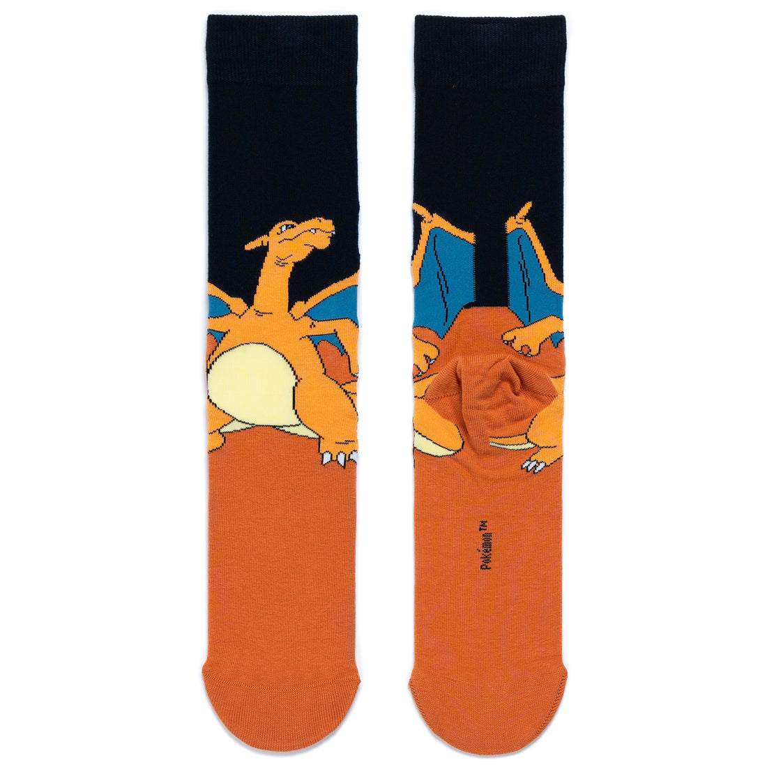 Front and back pair of crew socks laid flat side by side featuring a graphic of the Pokémon Charizard. The upper section is black with Charizard and its blue lined wings, while the lower section and toe area are a solid brown.