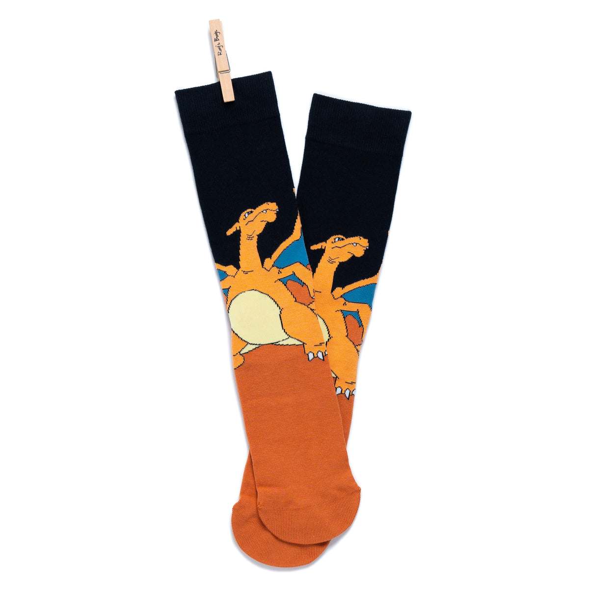 A pair of Pokémon Charizard crew socks hanging crossed and clipped together at the top by a small wooden peg