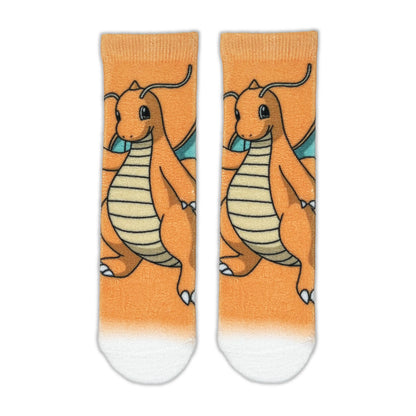 A pair of crew socks featuring a cartoon illustration of Dragonite on an orange background with a white toe section.