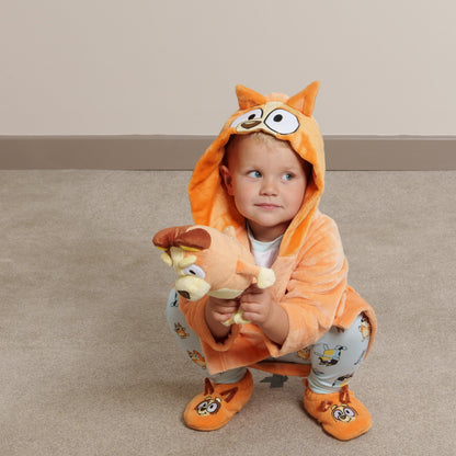 Life style image of boy wearing Bingo dressing gown, matching Bingo slipper socks and Bluey fam jams