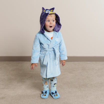 Life style image of boy wearing Bluey dressing gown, matching Bluey slipper socks and Bluey fam jams
