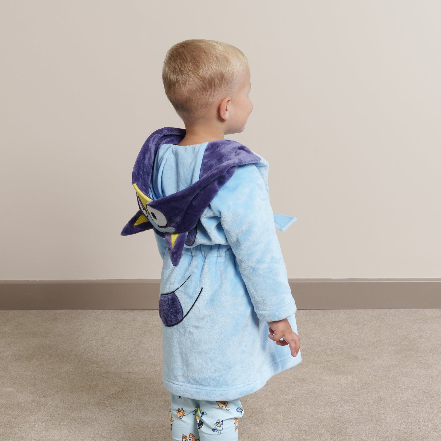 Boy wearing Bluey dressing gown and Bluey pyjamas