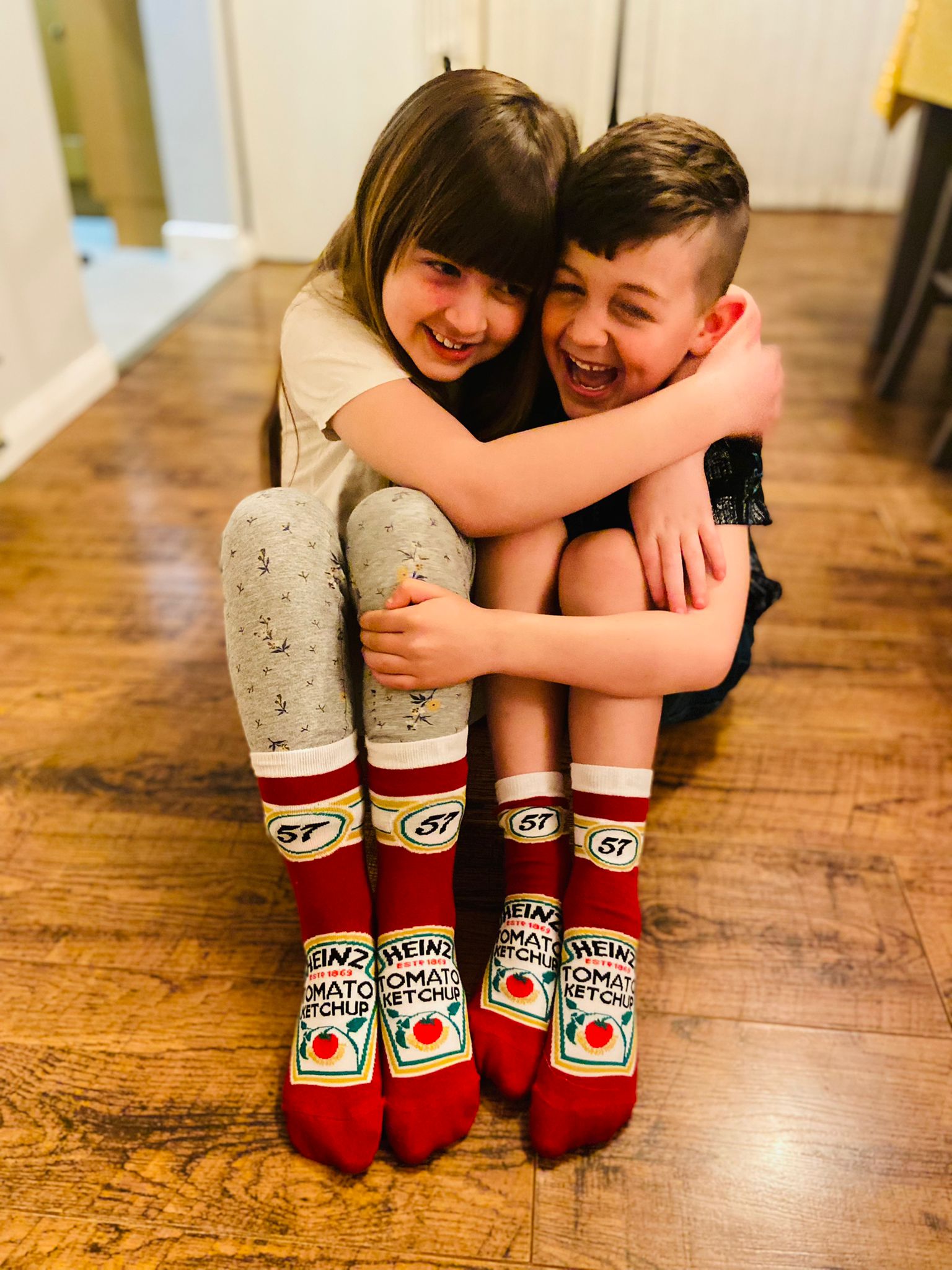 Two kids wearing the iconic ketchup 57 embroidered socks
