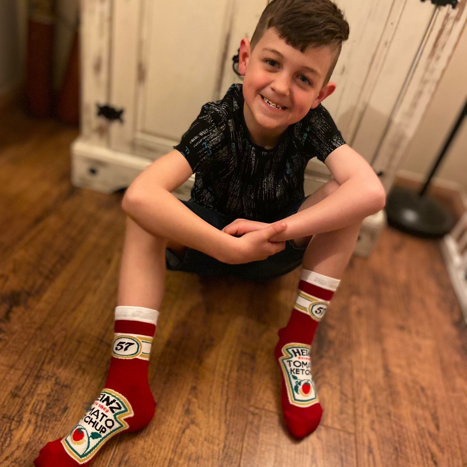 Lifestle image of a child wearing the Ketchup novelty socks