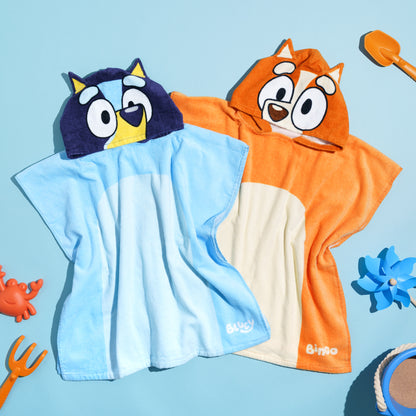 Bluey and Bingo ponchos on a blue background surrounded by beach themed activities