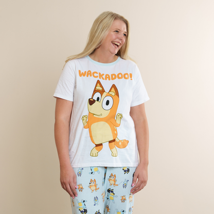 A woman modeling a white graphic t-shirt with an orange cartoon dog (bingo) and the word &